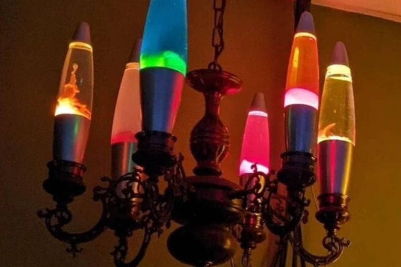 An expansive meme dump gallery capturing unhinged social interactions and bizarre visual comedy, featuring a gas station counter with two men wearing opposite message shirts, a Victorian ceiling chandelier fitted entirely with glowing lava lamps, and an Obvious Plant "Oops I... CRABBED MY PANTS" plush jazz crab toy.