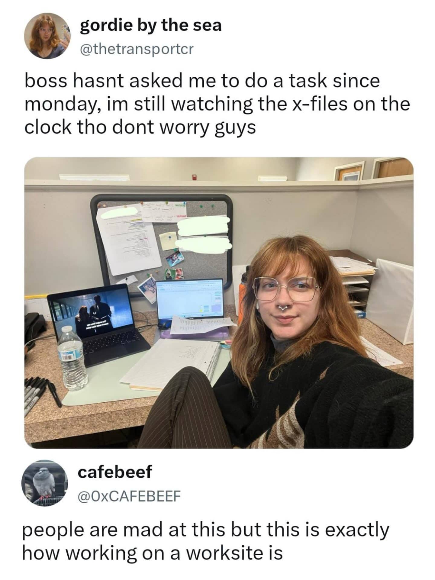 Office worker taking selfie sitting in cubicle watching TV shows on laptop while working on clock.