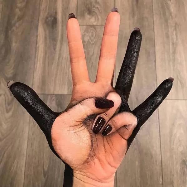 Hand painted with black makeup creating bizarre multi finger optical illusion body paint meme.