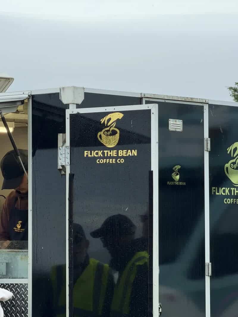 Black coffee truck sign displaying the double entendre business name Flick the Bean Coffee Co.