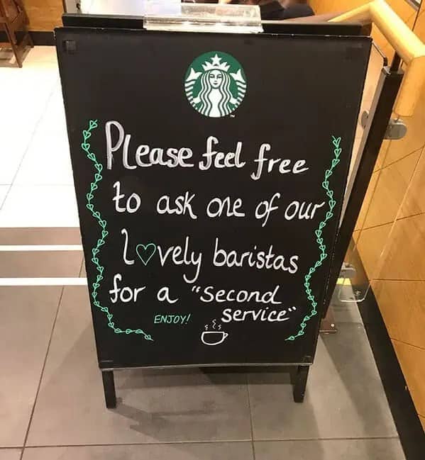 Starbucks chalkboard sign offering customers a second service written with misused quotation marks around phrase.