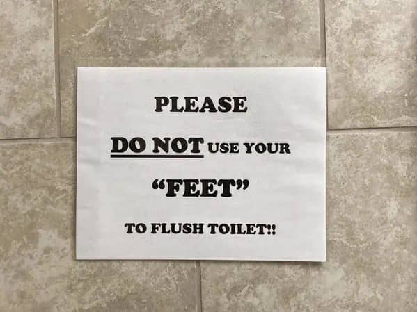 Bathroom notice instruction telling users not to use their feet with quotes around word feet.