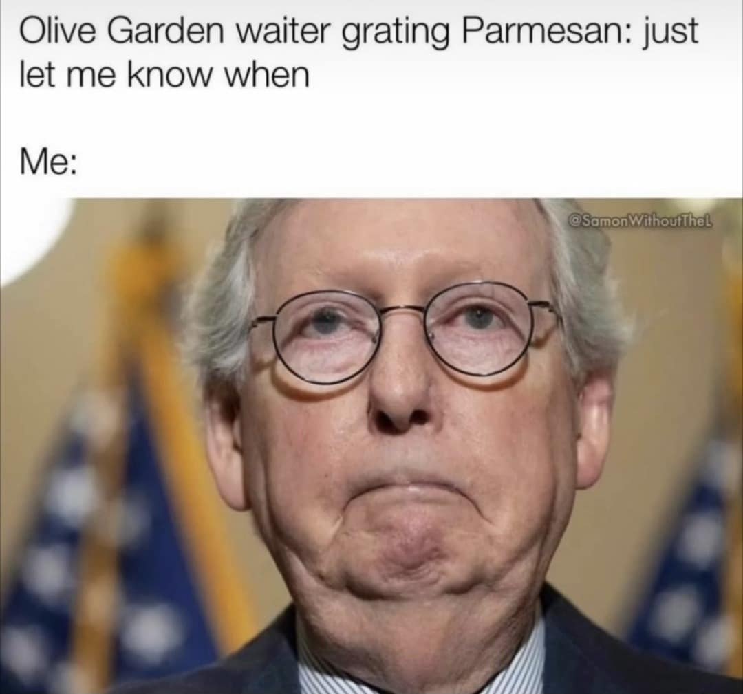 A hilarious restaurant culture Mitch McConnell meme showing an ultra-tight close-up of McConnell's deadpan, pursed-lip expression under text describing an Olive Garden waiter waiting for a customer to say "when" while grating cheese.