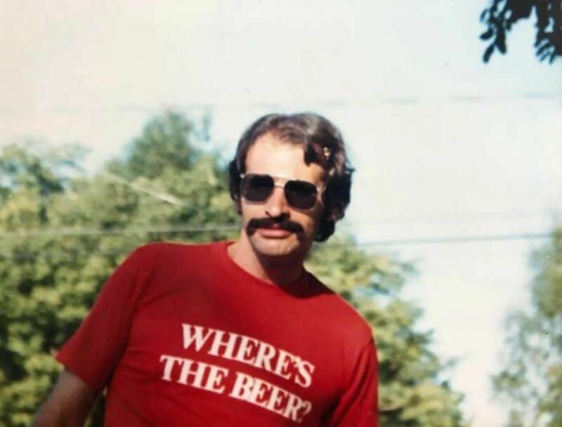 Old school cool man wearing a red t-shirt asking where the beer is.