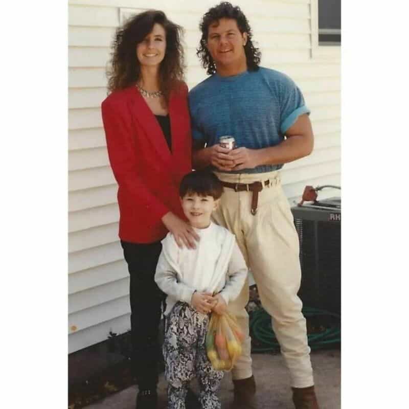 Old school cool family wearing eighties fashion, pleated pants, and mullet hairstyles outside.