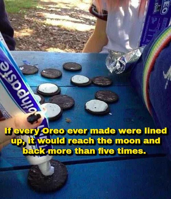 A cursed prank photo of someone squeezing white toothpaste onto disassembled Oreo cookies on a picnic table, overlaid with an astronomical random fact stating that lining up every Oreo ever made would stretch to the moon and back over five times.