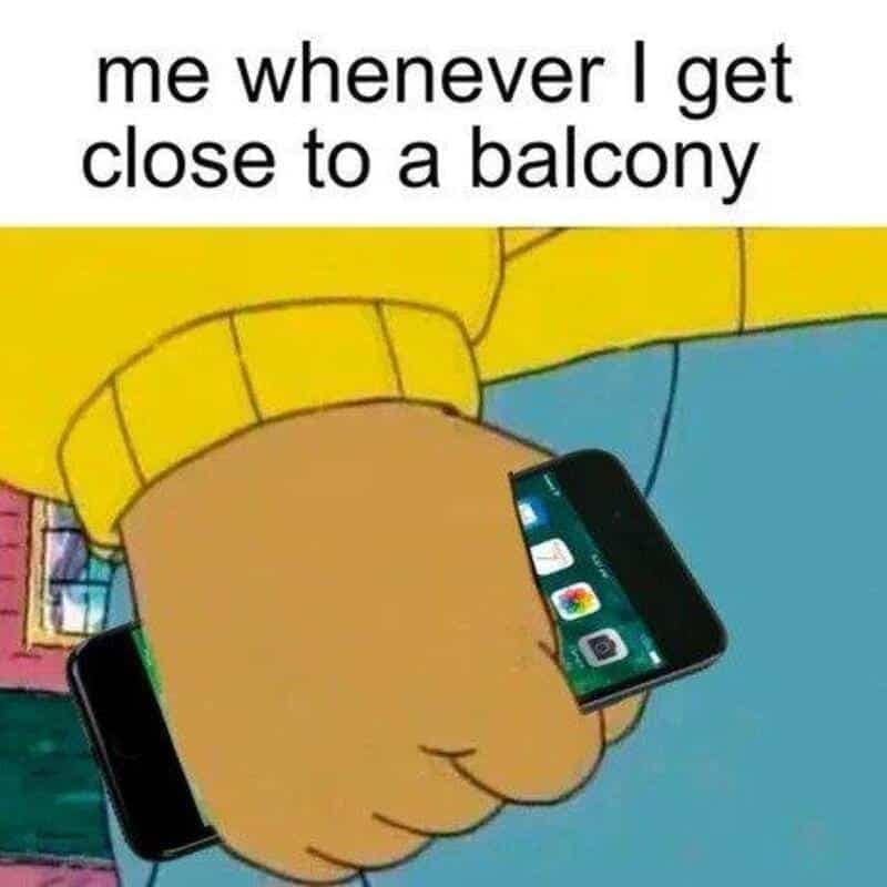 Arthur's clenched fist holding a smartphone tightly, representing the survival instinct of gripping your phone when standing near a high balcony edge.