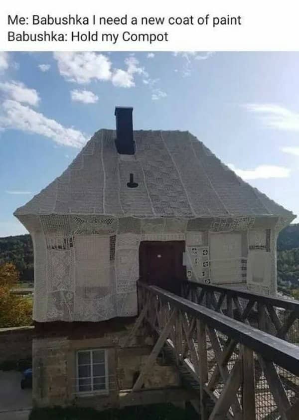 A house exterior fully covered in custom knitted white lace blankets by a crafty babushka.