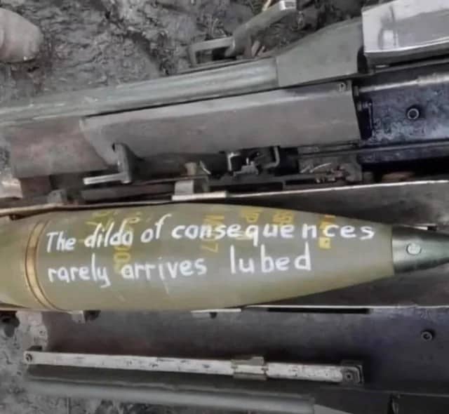 Military artillery shell stencil painted with a sarcastic message about the consequences of actions.