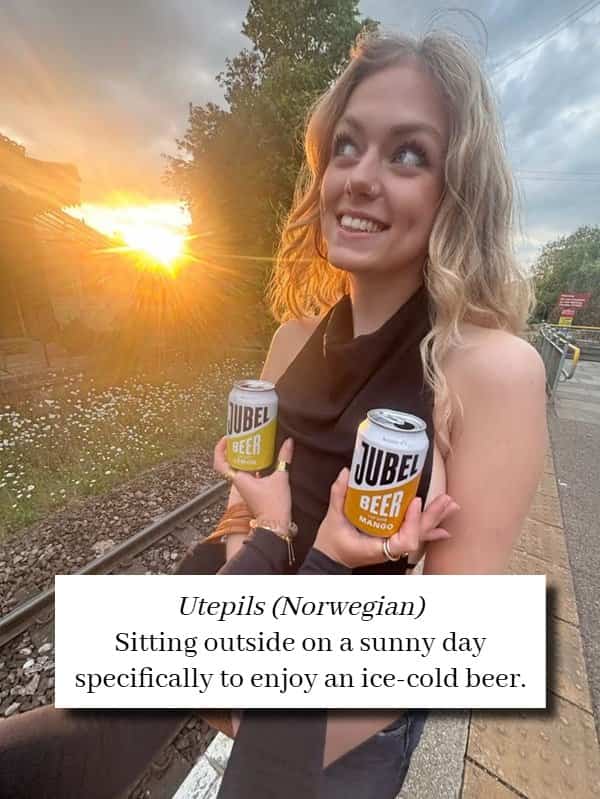 Smiling blonde woman with beer outdoors illustrating the Norwegian word Utepils for outdoor drinking.