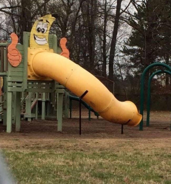 Yellow banana tube slide featuring hilariously inappropriate design choices at the worst playgrounds.
