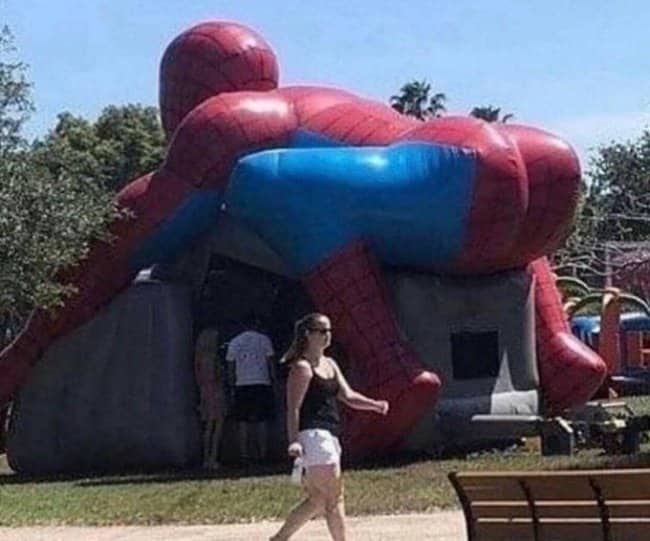 Giant inflatable Spiderman bouncy house with an extremely unfortunate entrance placement highlighting worst playgrounds.
