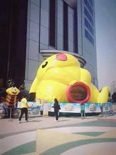 Giant Pikachu inflatable structure with a deeply disturbing crotch entrance tunnel at the worst playgrounds.