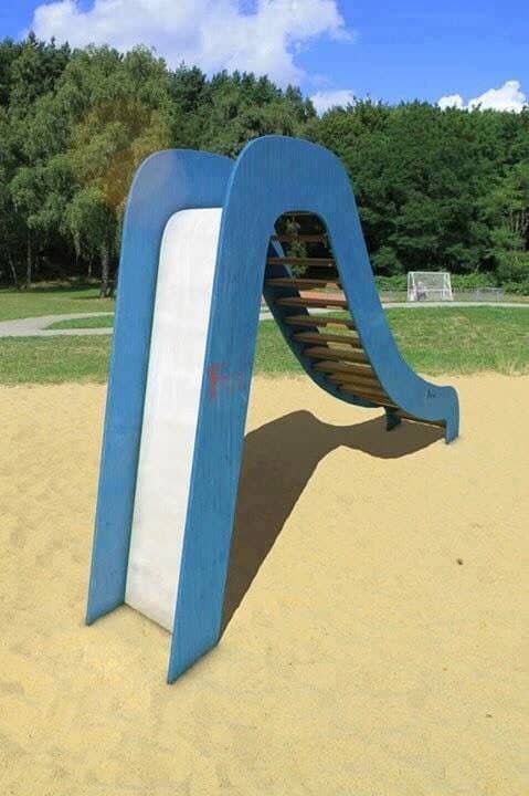 Bizarre wooden playground slide with a dangerously steep drop off representing poorly designed worst playgrounds.