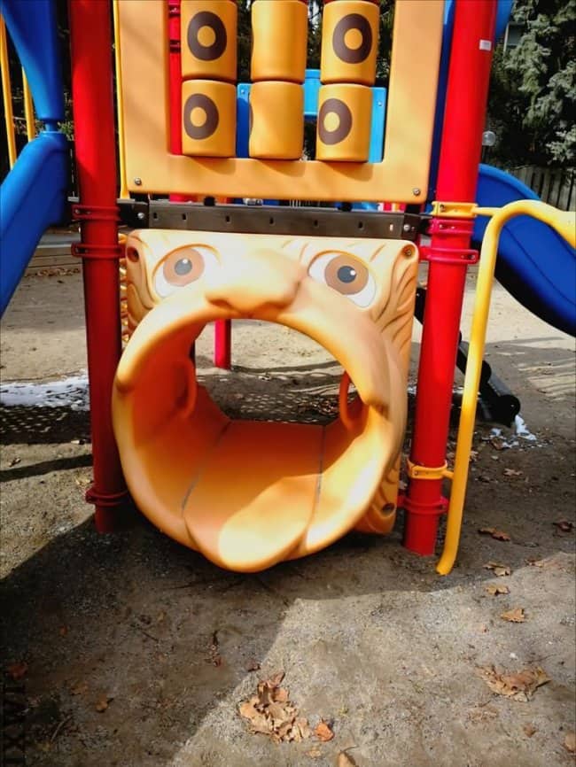 Creepy playground tunnel entrance shaped like a face with a gaping mouth at worst playgrounds.