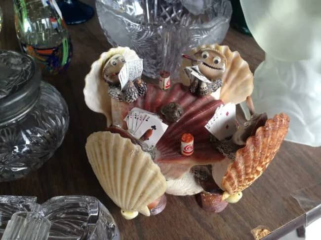 Creepy seashell diorama thrift store find depicting anthropomorphic clams playing poker and drinking tiny sodas.
