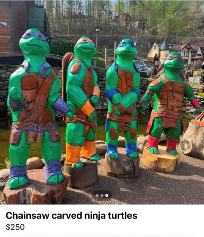 Hilariously bad chainsaw carved Teenage Mutant Ninja Turtles statues spotted at a roadside flea market.