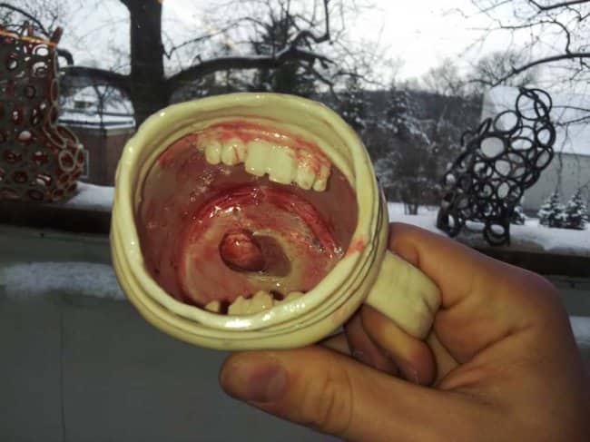 Horrifying ceramic coffee mug thrift store find modeled to look like a bloody human mouth.