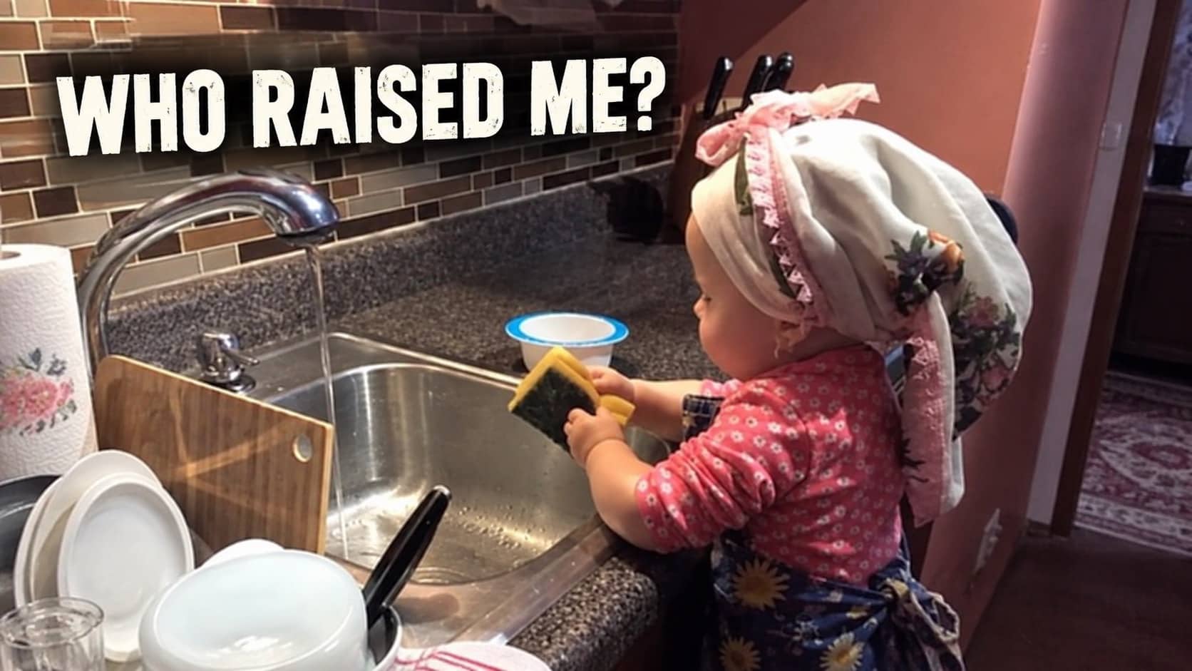 Toddler wearing headscarf standing on stool washing dishes in sink for balkan memes gallery.