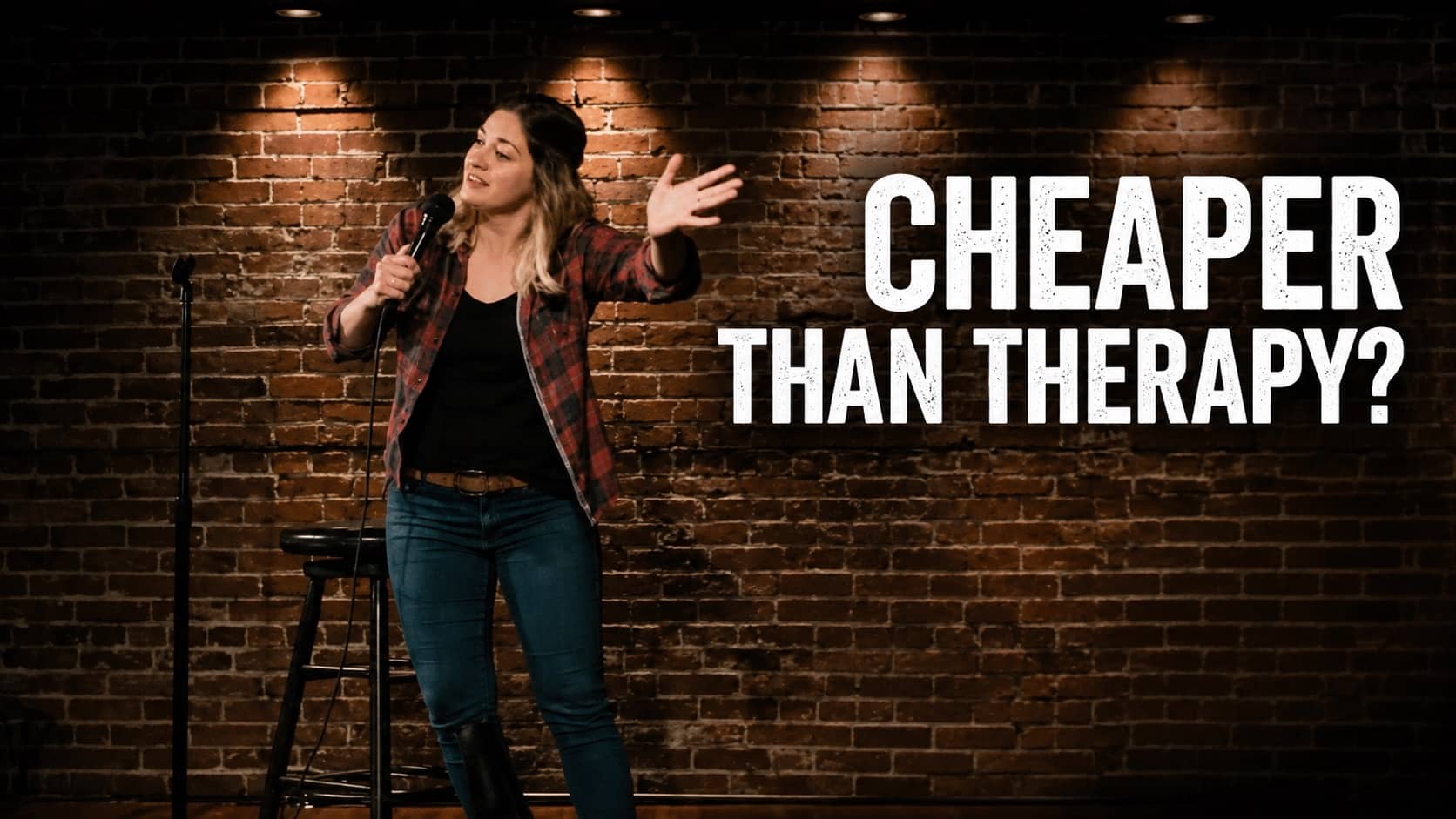 Female comedian performing stand up comedy on stage with text reading cheaper than therapy.