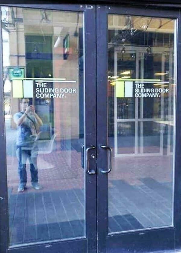 Glass doors branded The Sliding Door Company are clearly hinged doors with pull handles.
