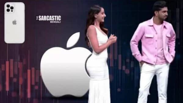 Woman in white stands in front of a giant Apple logo during a product presentation.
