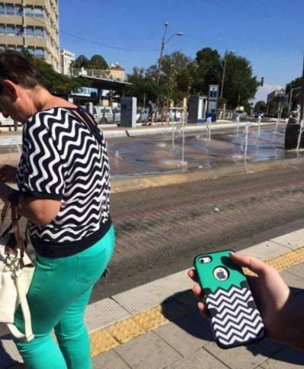 A phone case pattern matches a stranger's zigzag top perfectly on a sunny city street.