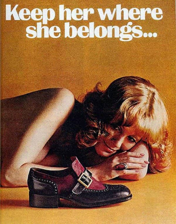 Shoe ad reading keep her where she belongs, showing a woman lying beside a shoe.