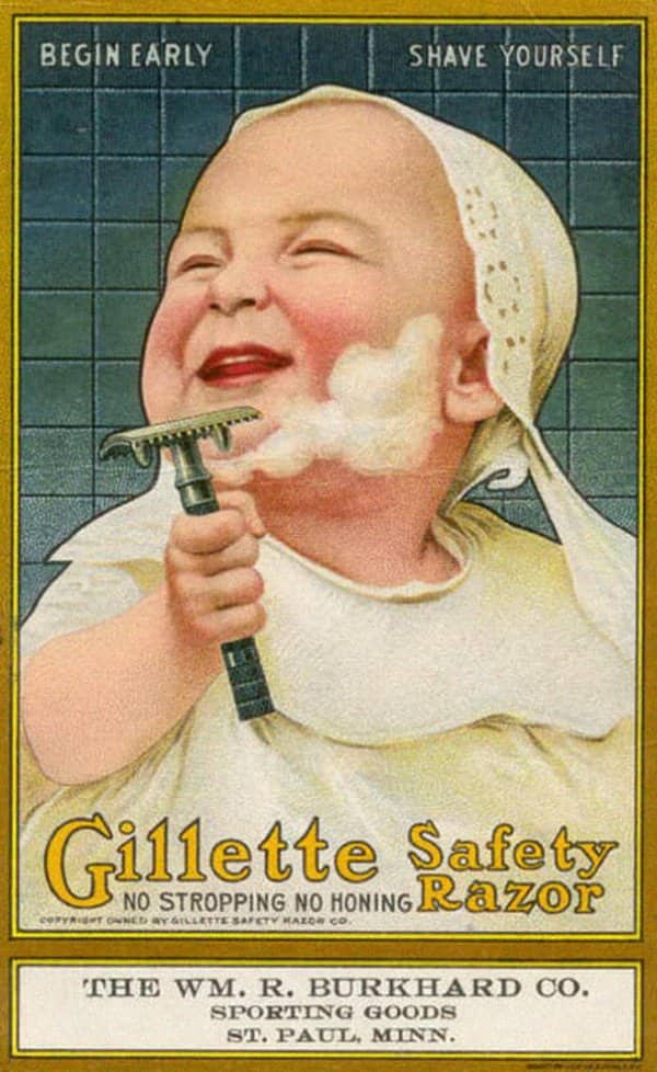 Gillette safety razor ad showing a laughing baby with shaving foam holding a razor.