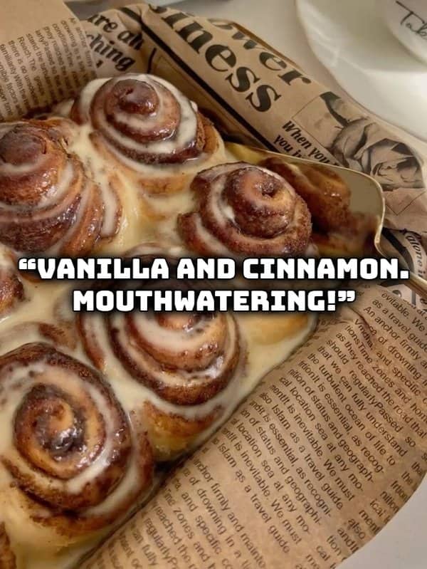 Freshly baked cinnamon rolls coated in vanilla icing representing delicious bakery scents and smells.