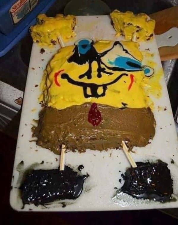 Sheet cake decorated as a square cartoon character with runny yellow frosting and smeared features