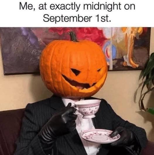Person wearing a suit and carved pumpkin head sitting formally while drinking tea to kick off autumn on September 1st in a classic meme.