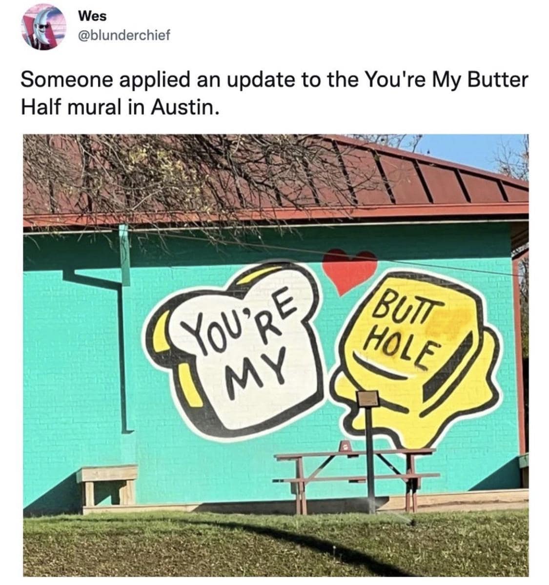 Vandalized street mural in a classic meme showing the famous Austin 'You're My Butter Half' toast art spray-painted to read 'You're My BUTT HOLE'.