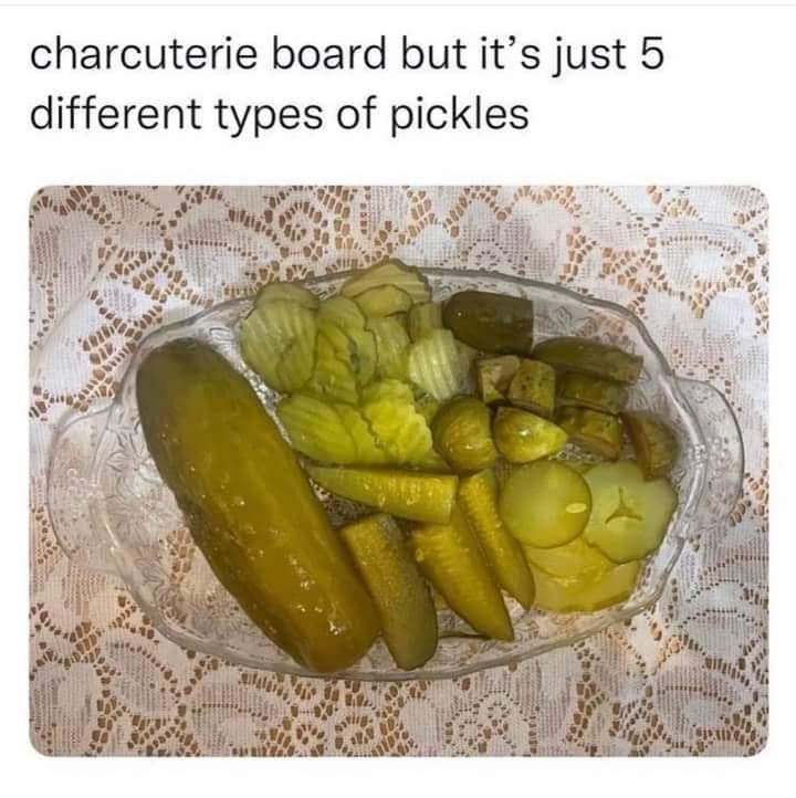 Glass appetizer dish filled with five distinct cuts and varieties of dill pickles, humorously labeled a pickle charcuterie board in a classic meme.