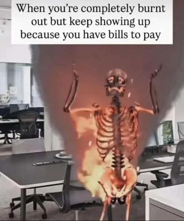 Flaming 3D skeleton raising its hands in an office space, captioned about working through total burnout to pay bills as an old meme.