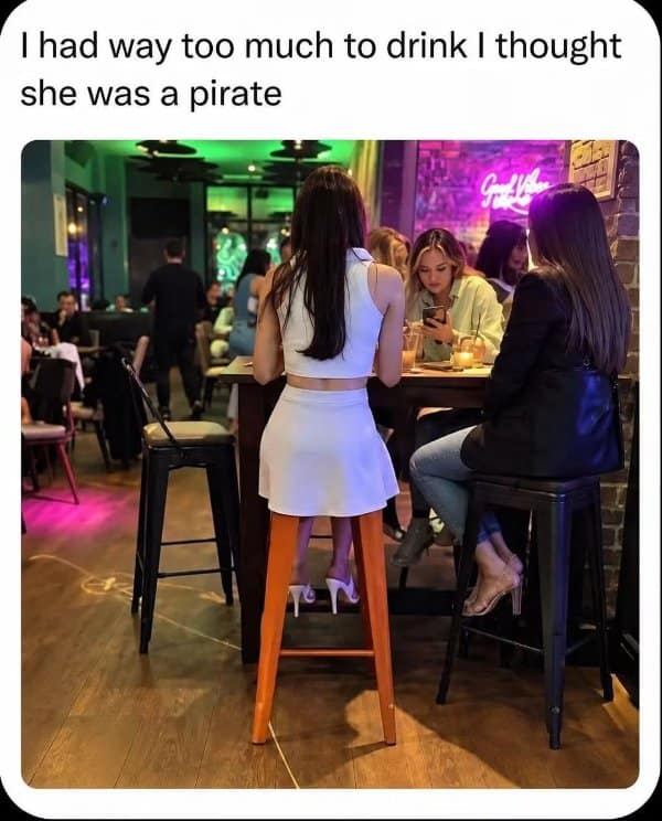 Confusing images bar scene where a woman's leg lines up with an orange stool leg.