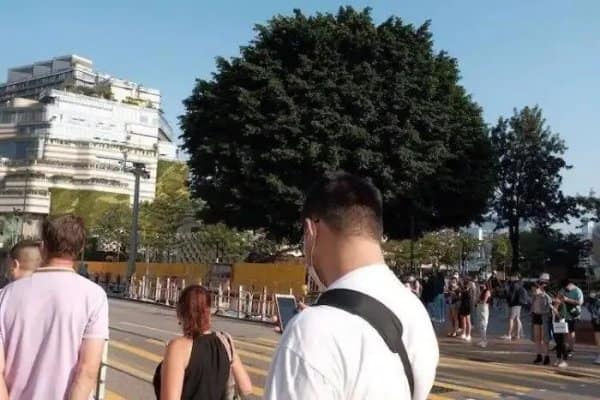 Confusing images moment where a man's backpack strap seems to belong to a stranger's outfit.