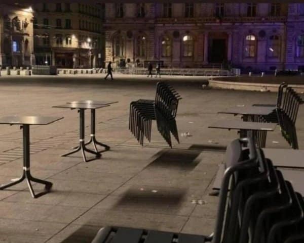 Confusing images from a plaza where stacked chairs cast shadows that make tables float.