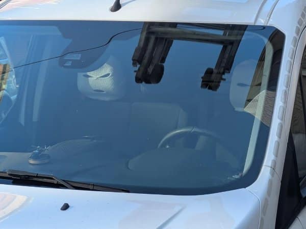 Confusing images windshield reflection that makes an empty seat look like a masked driver.