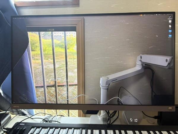 Monitor showing a window view so clear it looks like a hole in the wall.
