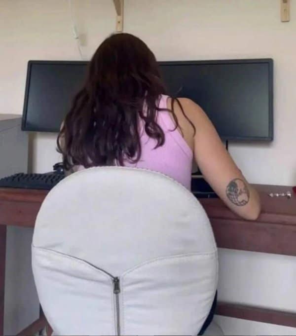 Confusing images like this woman at a desk whose round chair back looks like her body.
