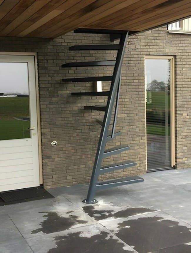 Floating spiral stair outside that stops well short of the ceiling above it.