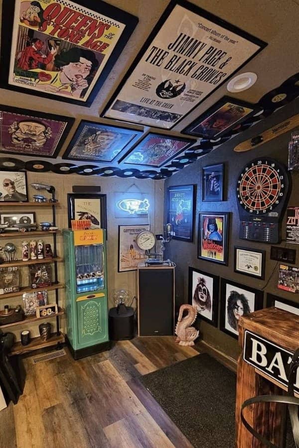 Small room packed with concert posters, records, a dartboard, neon signs and a vending machine