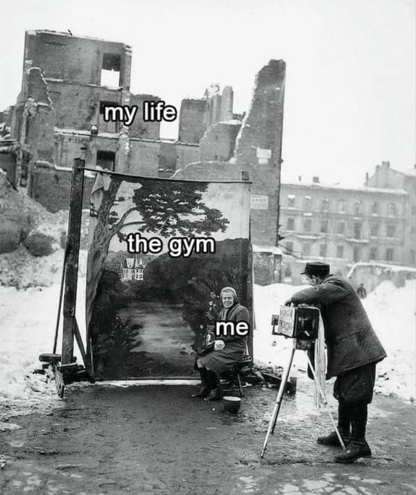 Vintage black-and-white photograph of a woman posing in front of an idyllic painted backdrop representing the gym while surrounded by bombed-out city ruins in a diet meme.