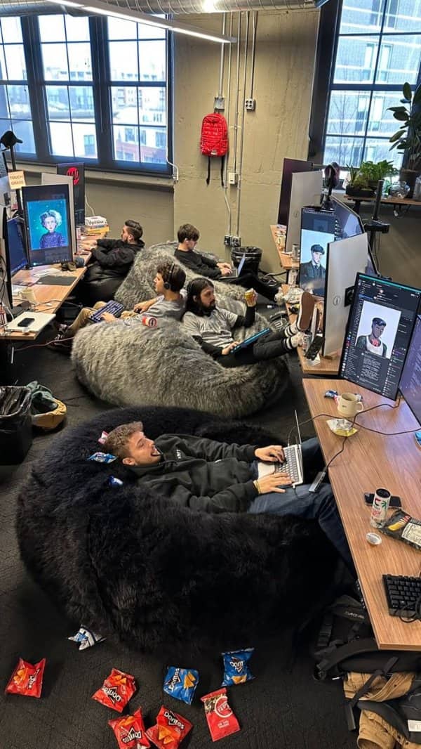 Office tech workers lounging in massive bean bag chairs eating chips dystopian future memes.