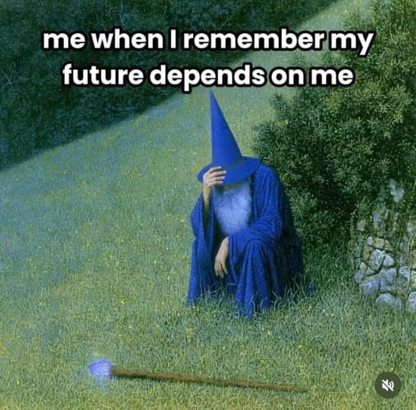 Blue-robed wizard sitting face-in-hand in deep existential dread on a grassy hill with his staff lying abandoned on the ground in a fantasy meme.