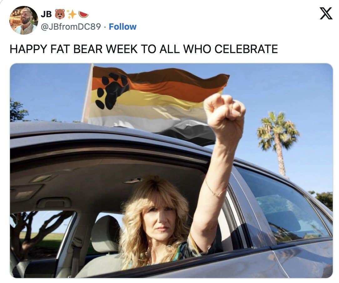 Woman raising a fist out of a car window beside a bear pride flag to celebrate bear week