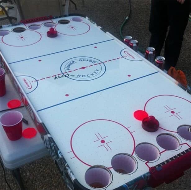 An air hockey table modified with plastic cups created for unique funny drinking games.