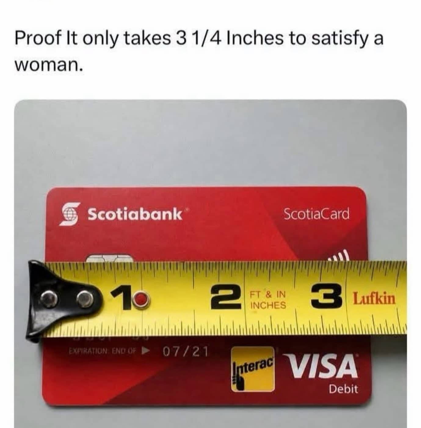 Tape measure placed across red Scotiabank Visa debit card showing card length in inches.