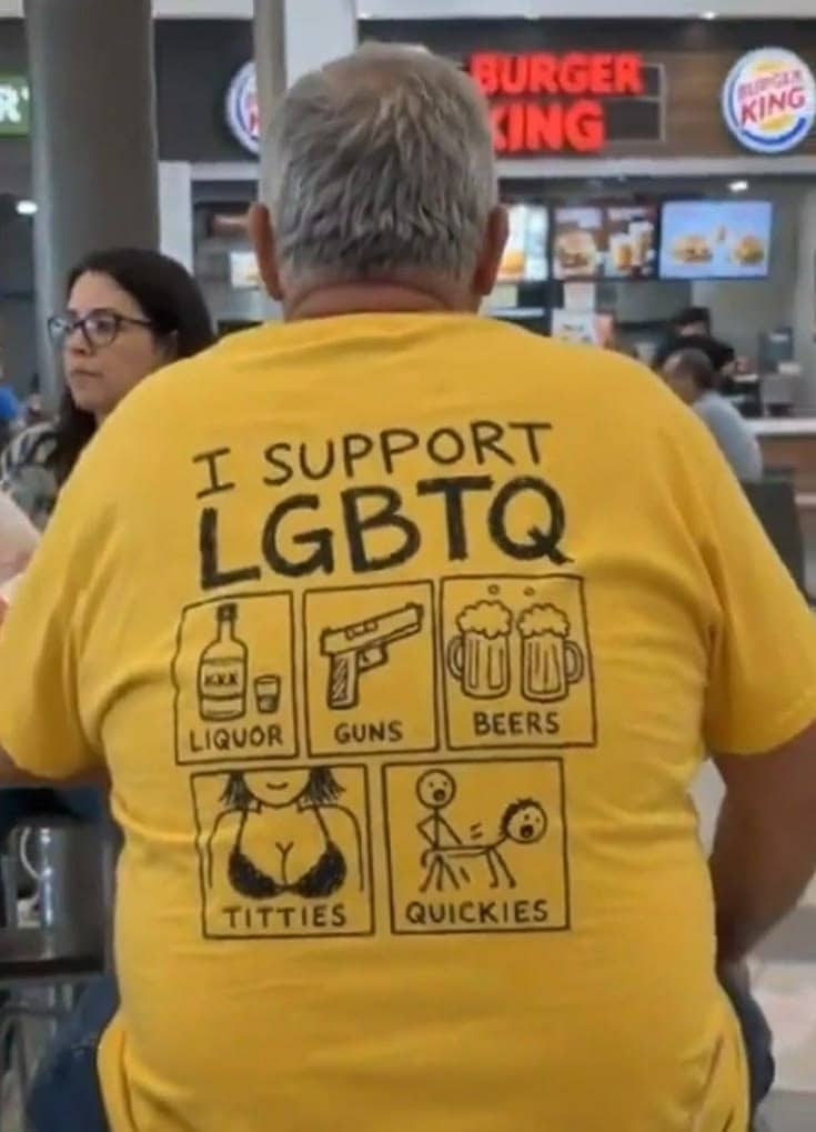 Man wearing a yellow t-shirt with a humorous alternative LGBTQ acronym design.
